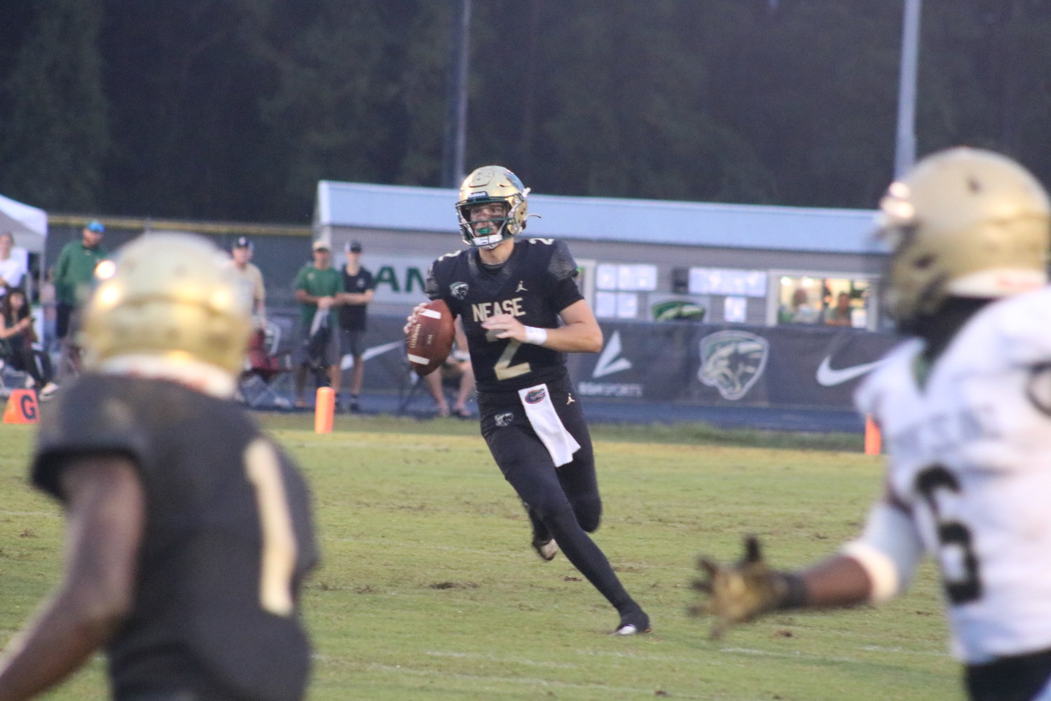 Nease quarterback Marcus Stokes rolls out and looks downfield against Fleming Island.